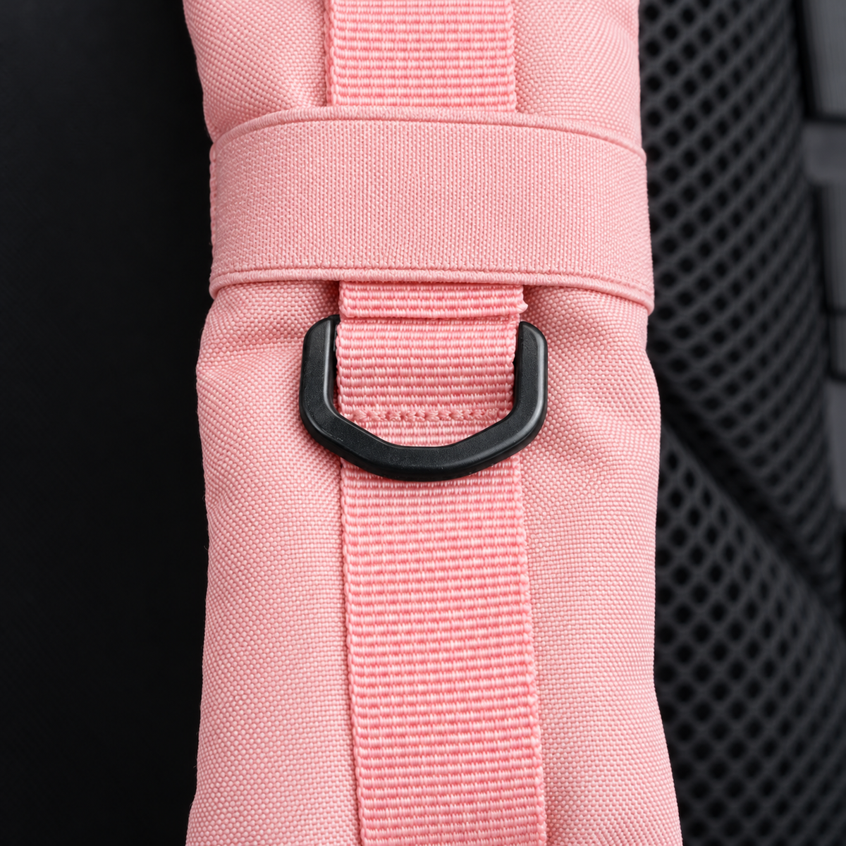 light pink backpack – shoulder strap with black fitting detail