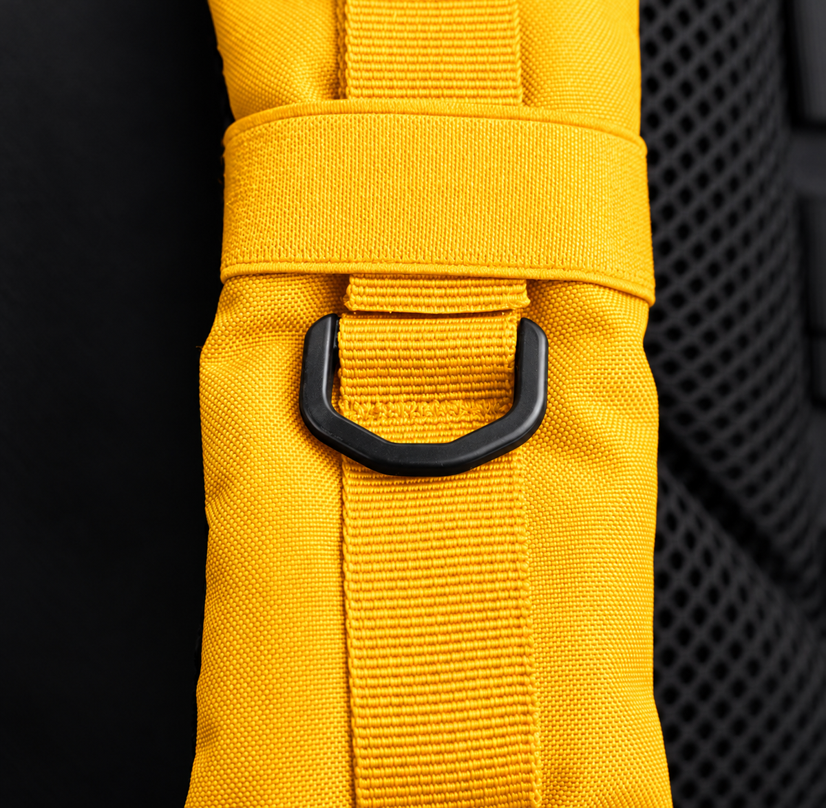yellow backpack – shoulder strap with black fitting detail