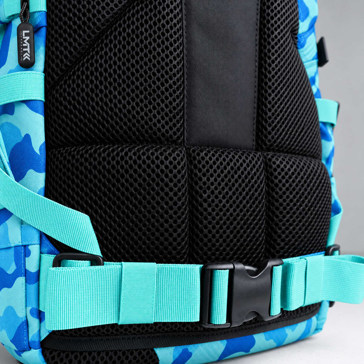 blue camo backpack – rear waist strap and black mesh detail