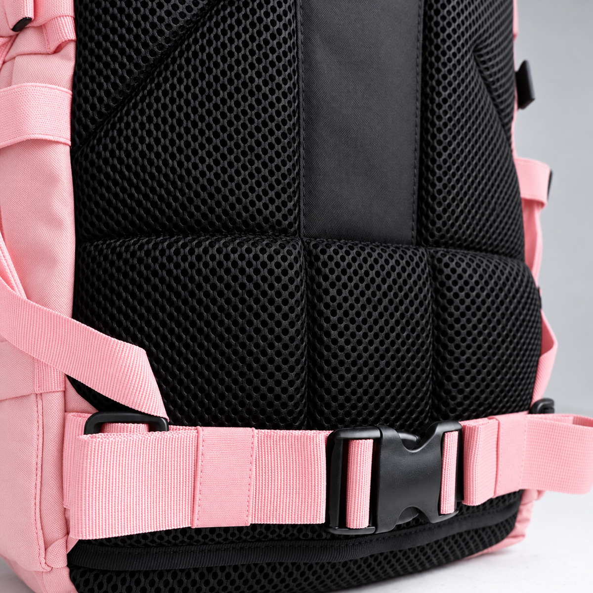 light pink backpack – rear waist strap and black mesh detail