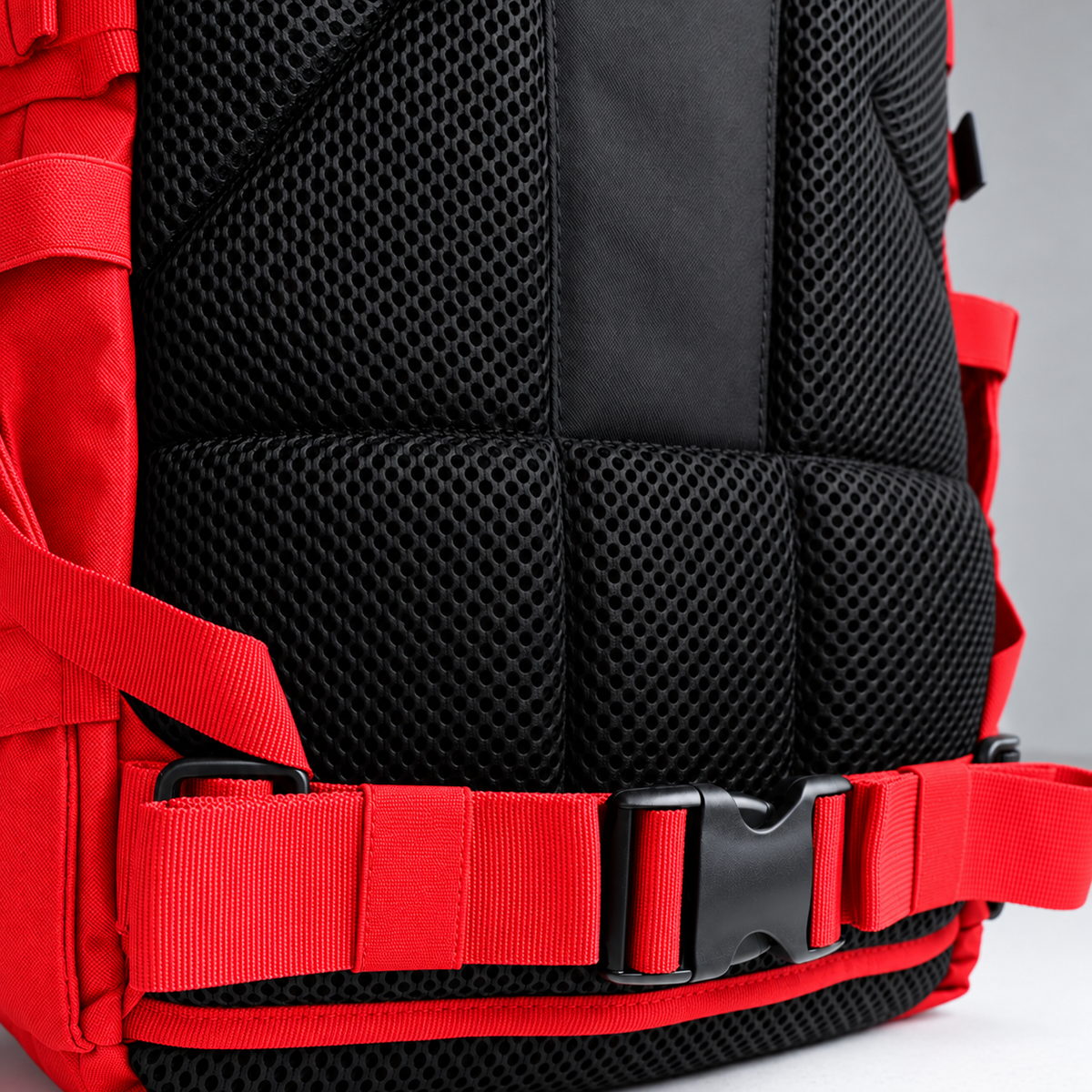 red backpack – rear waist strap and black mesh detail
