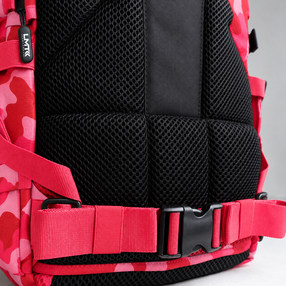 red camo backpack – rear waist strap and black mesh detail