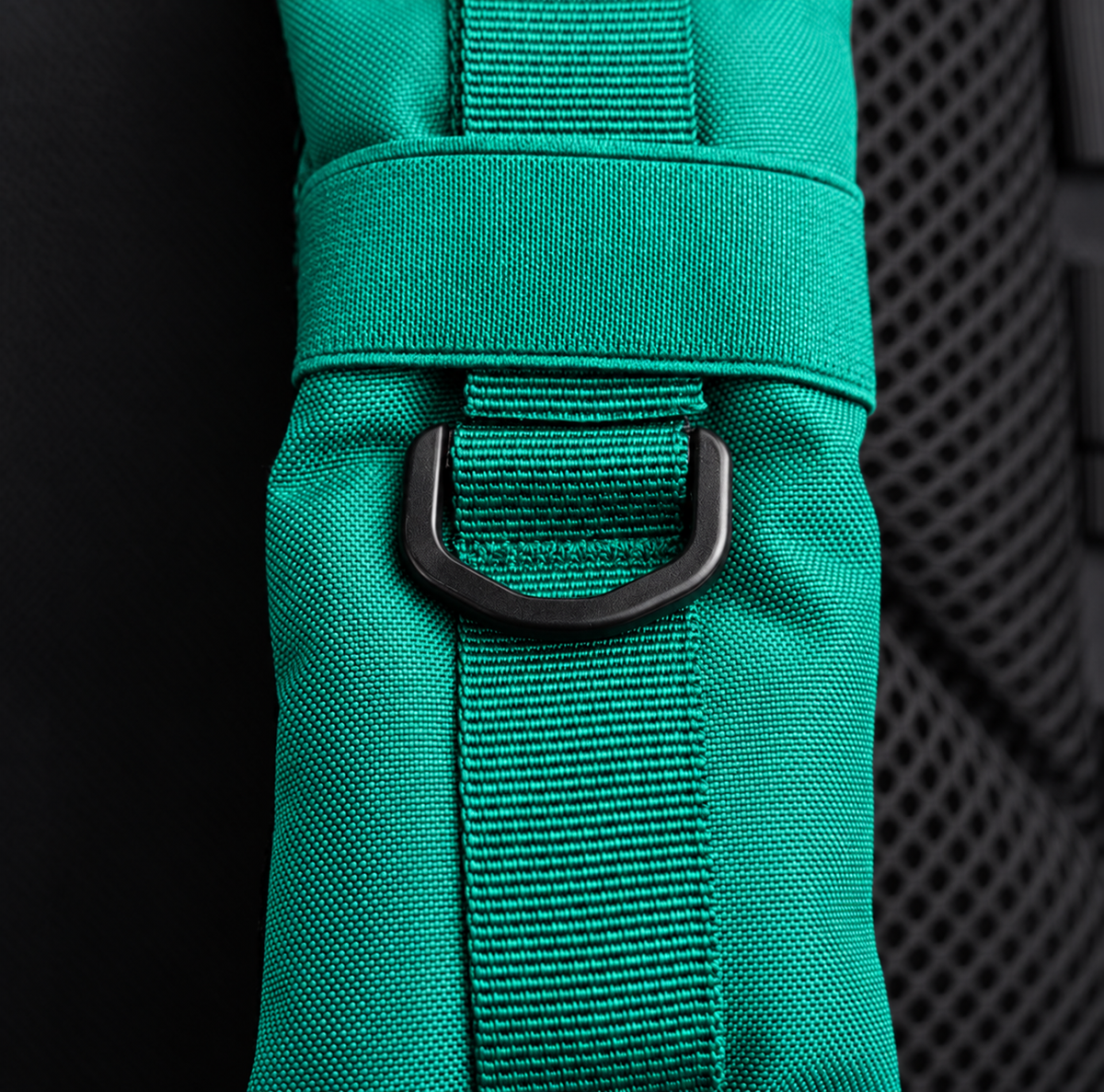 teal backpack – shoulder strap with black fitting detail