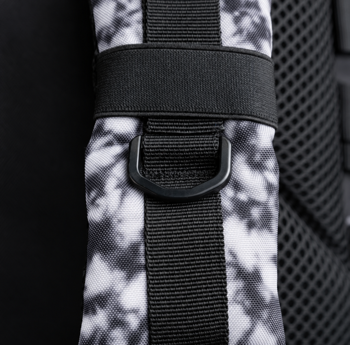white tie dye backpack – shoulder strap with black fitting detail